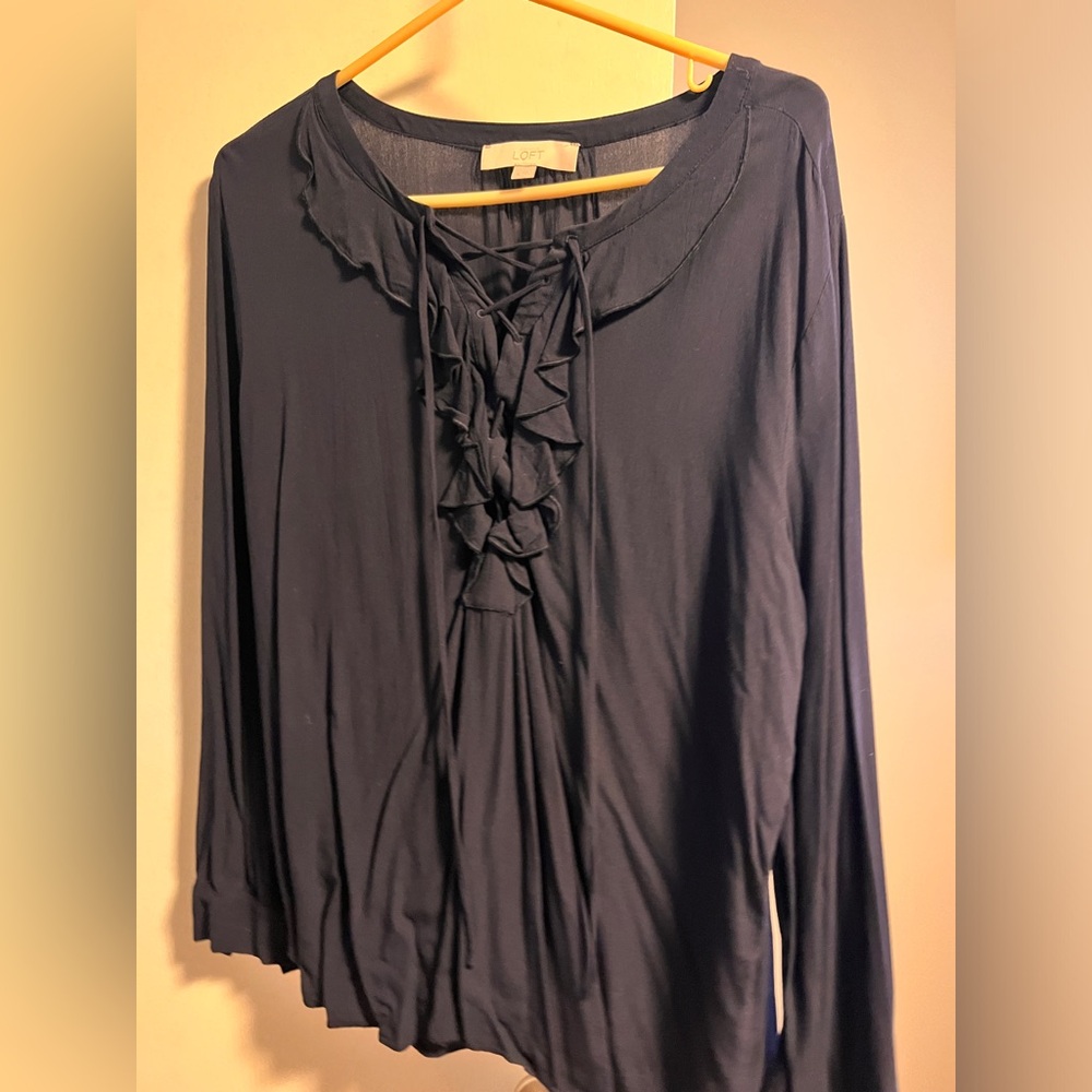 Dark blue long sleeve blouse from Loft. It has a ruffle front with ties